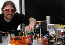 Graduate physicist Jonas Witzenrath at the quantum experimental setup of University Kaiserslautern, Germany