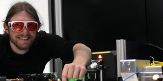 Graduate physicist Jonas Witzenrath at the quantum experimental setup of University Kaiserslautern, Germany